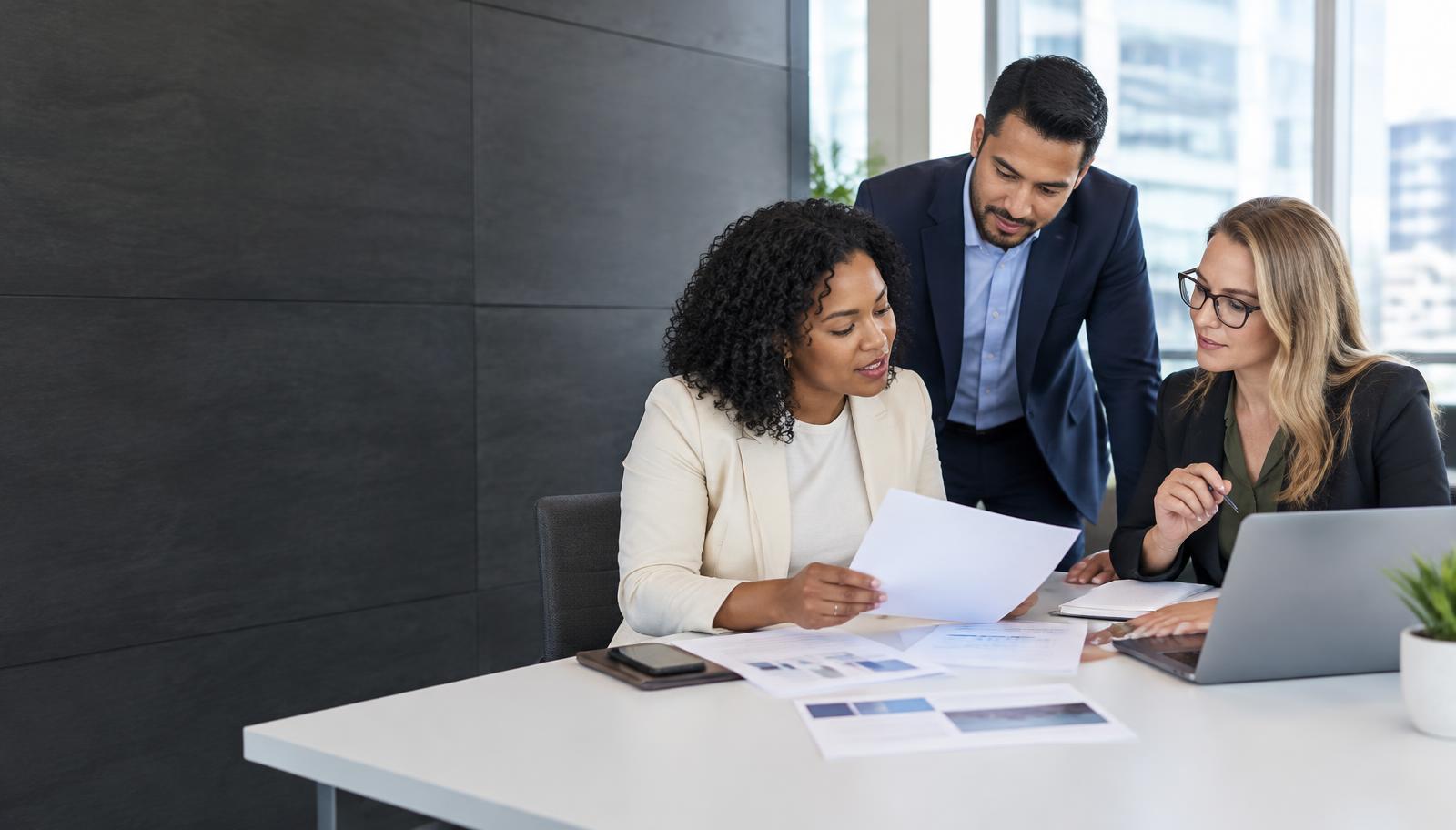 A contracting team reviewing a proposal together